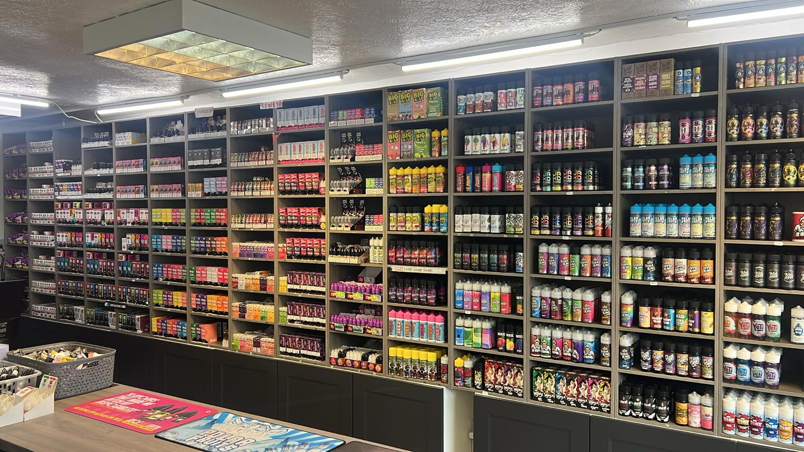 Close-up of assorted vaping devices and colourful e-liquid bottles offered by the online vape store- Irresistible Vapes rochester uk