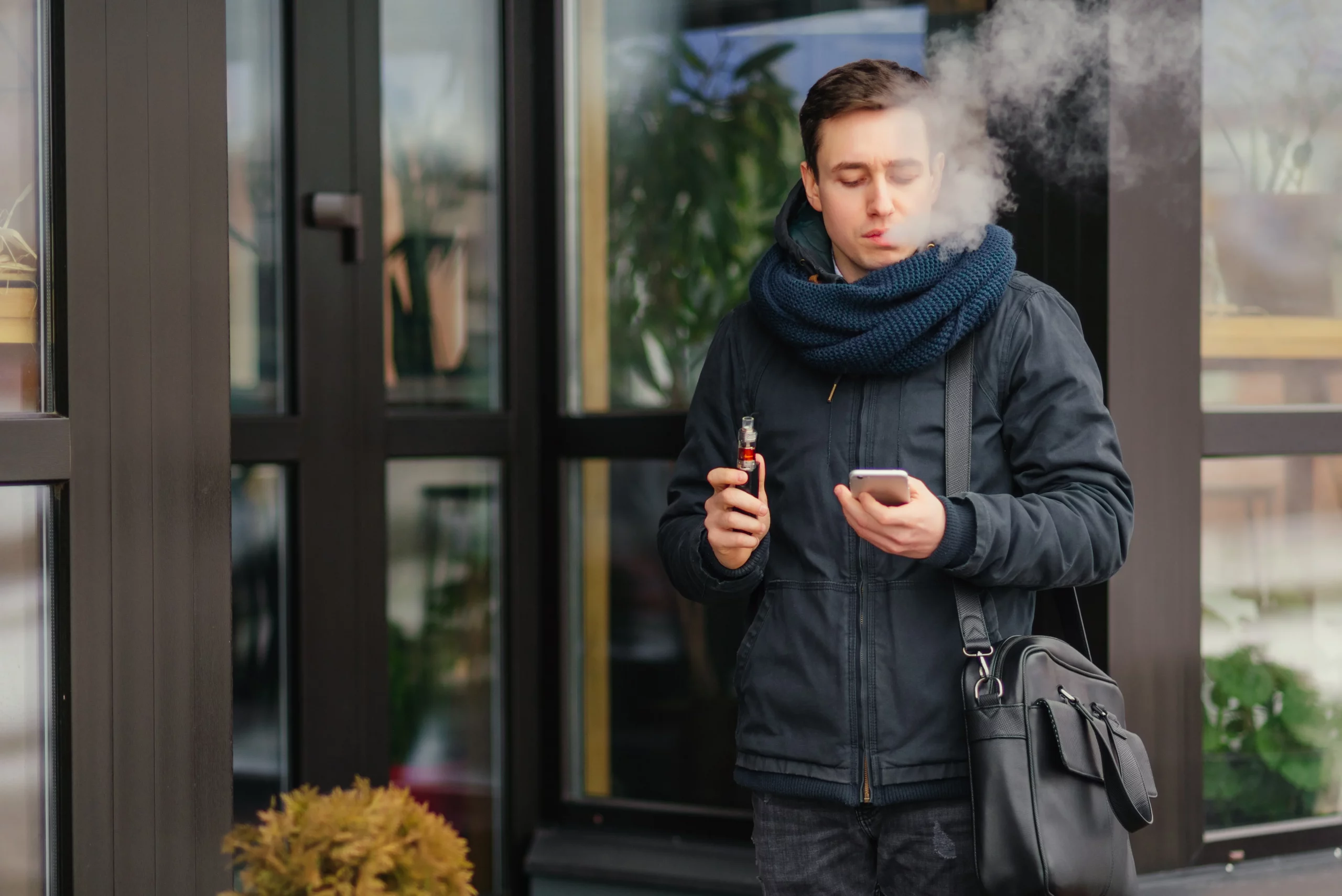 Person using a prefilled vape pod kit while relaxing at home